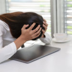frustrated woman at computer feeling stuck